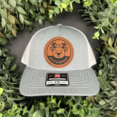 Engraved hat patch with reindeer and lights that says "Jolly and Bright"