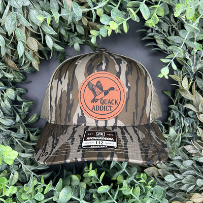Engraved patch of a duck on a camo hat