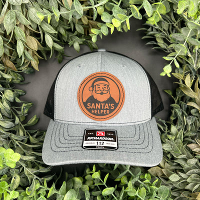 Gray and black cap with 'Santa's Helper' engraved on the patch.