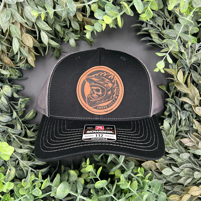 Hat with engraved patch of a skull with dirt bike helmet that says "Shred till I'm dead"